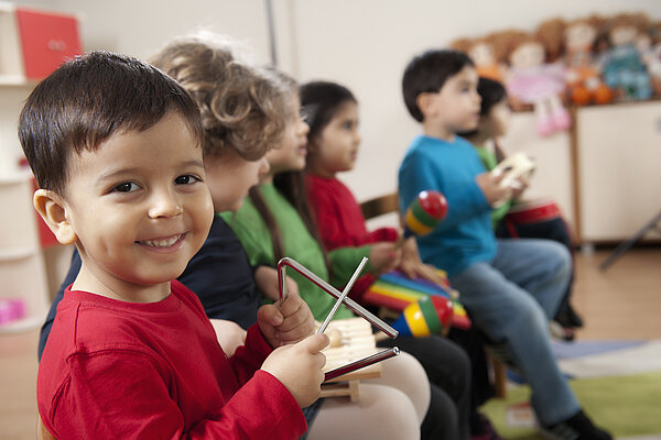 Preschool age children in music class