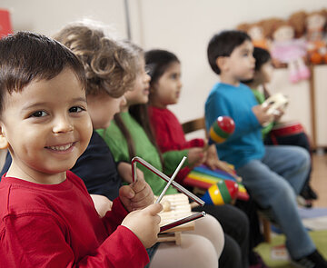Preschool age children in music class